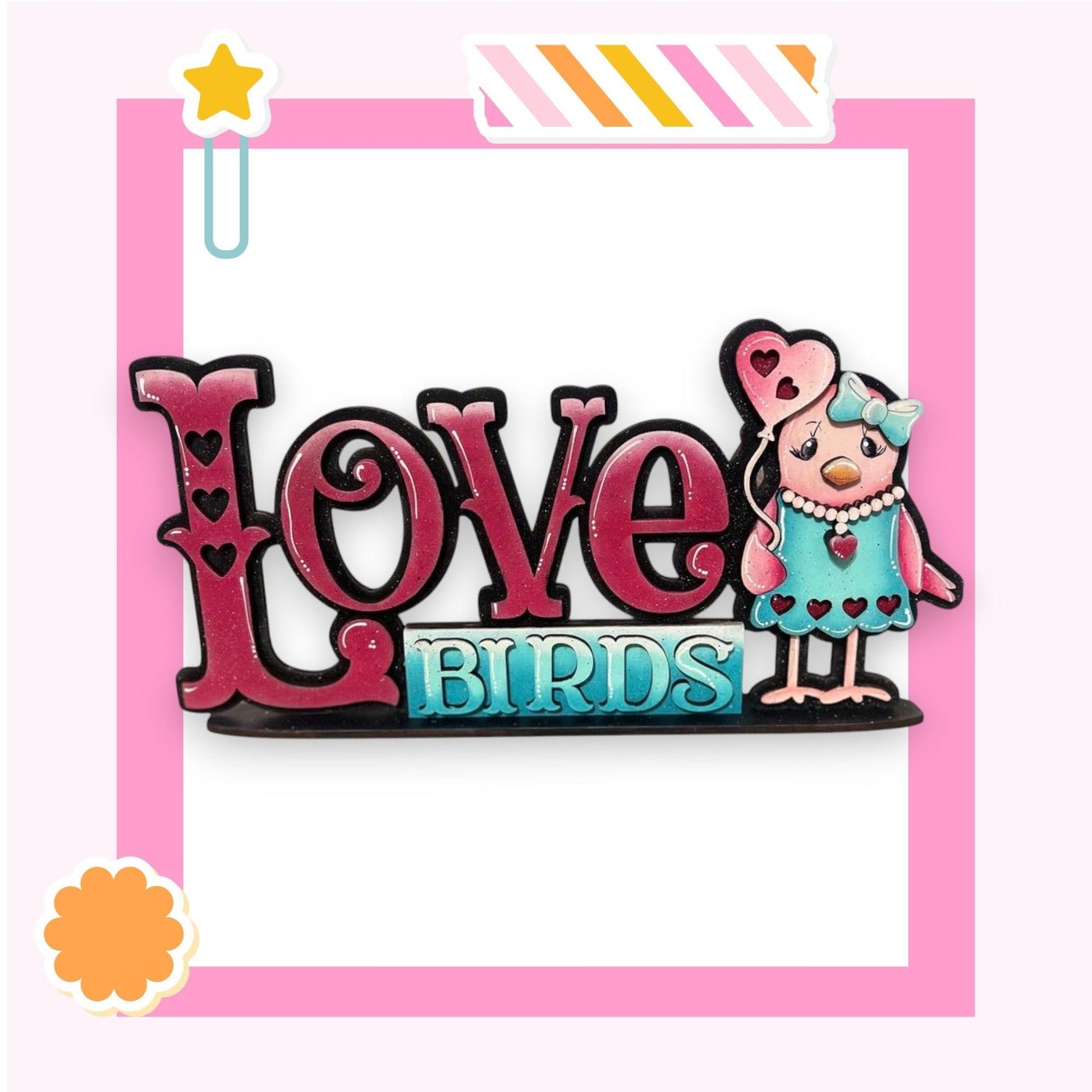 a picture of a pin with the word love birds on it