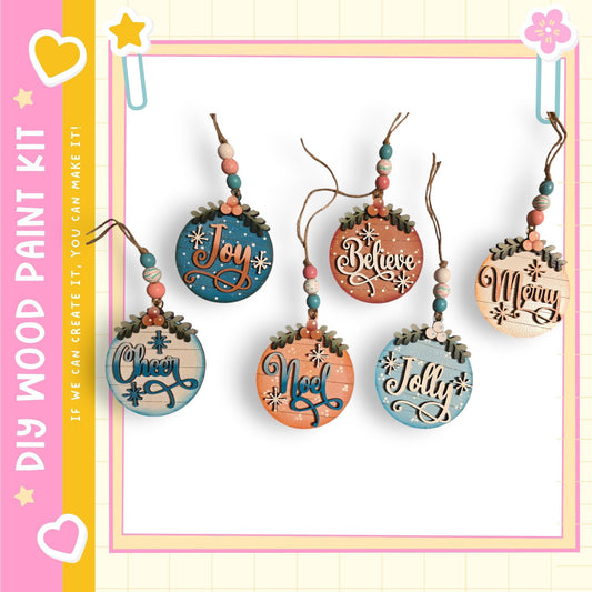 A collection of five wooden ornaments with various holiday-themed sayings hanging from strings.