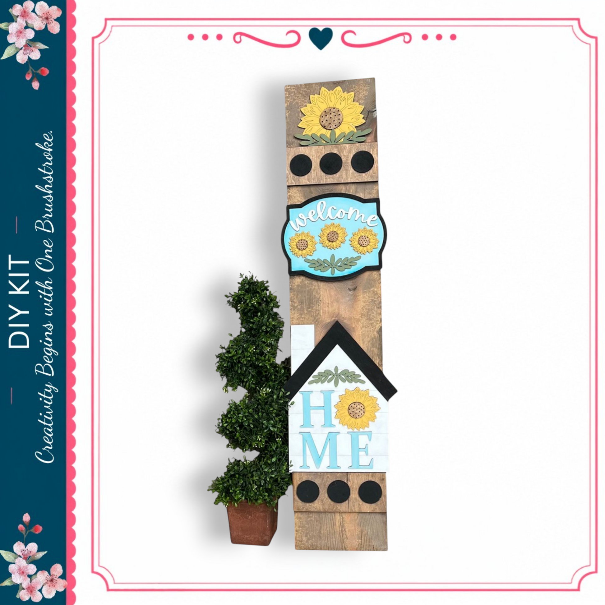 a wooden sign with a sunflower design, a potted plant, and a blue sign with the word "welcome" on it.