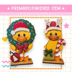 a couple of ducks wearing christmas hats and scarves