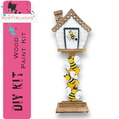a wooden birdhouse with a bunch of bees on it