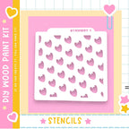 The image is a colorful and playful design featuring a white stencil with a repeating pattern of pink hearts against a pink background. The stencil is surrounded by various decorative elements such as hearts, stars, and a pink border.