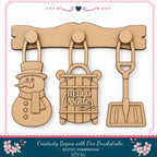 a DIY kit for creating winter-themed ornaments, including a snowman, a sled, and a shovel.