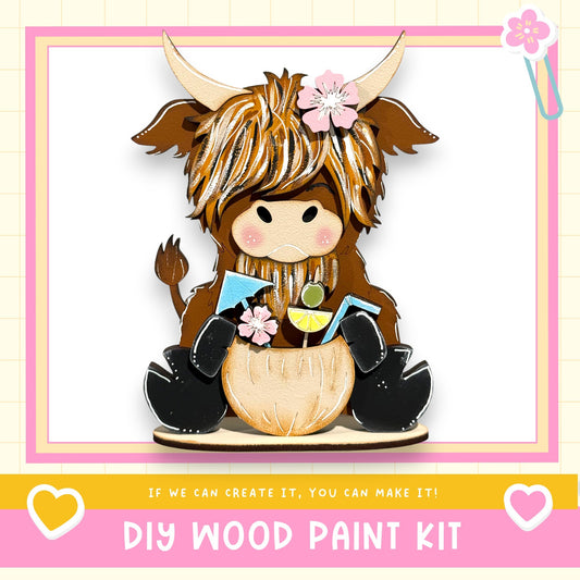 A wooden toy cow with horns and a flower in its hair, sitting on a wooden base and holding a small toy figure.