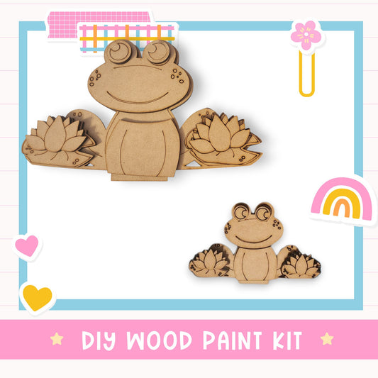 a DIY wood paint kit with two wooden frog-shaped figures, one larger and one smaller, along with a heart and a rainbow.