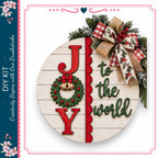 a festive holiday wreath with the word "Joy" written on it, surrounded by red berries and a bow.