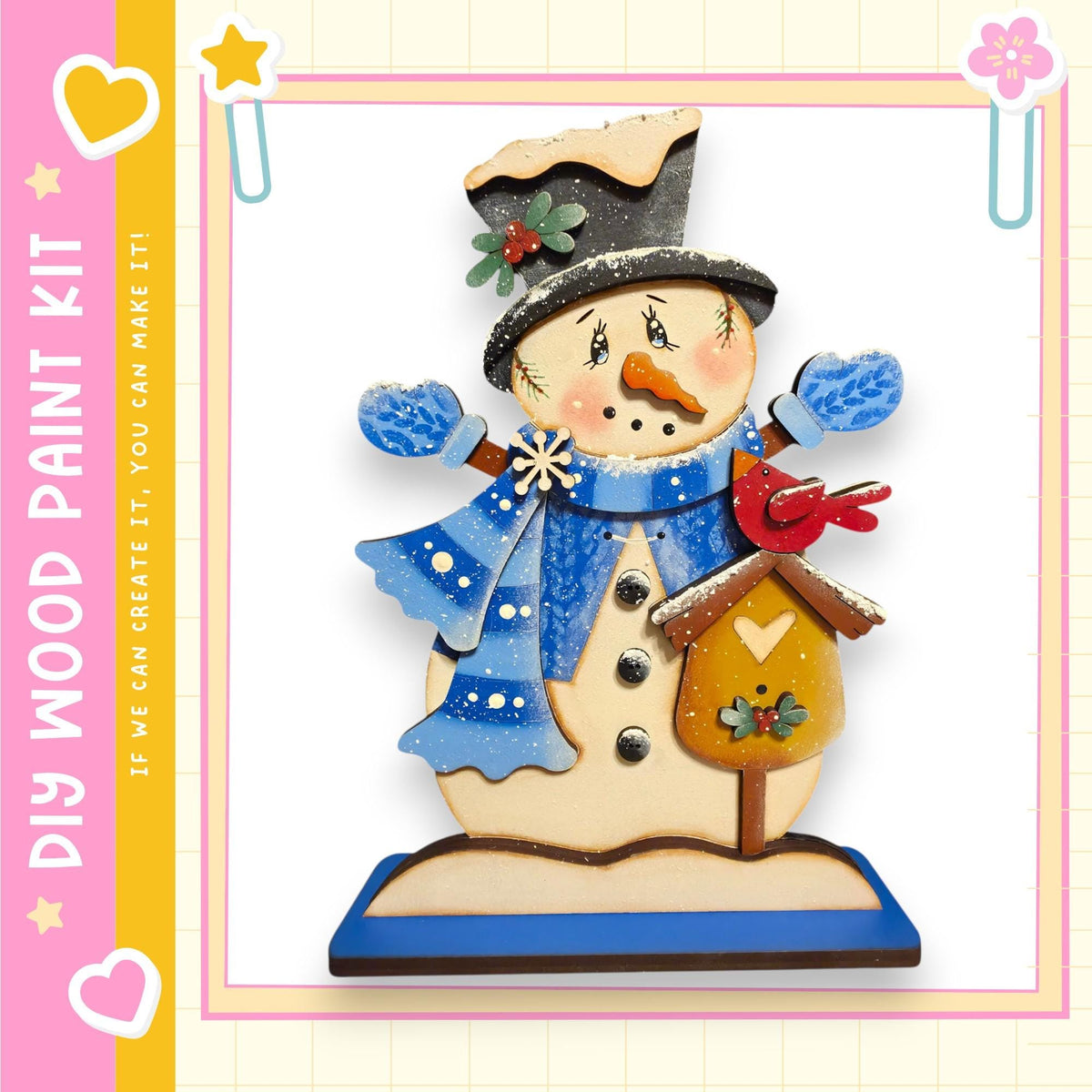 A wooden snowman figure with a bird perched on its roof, wearing a blue scarf and hat, and holding a birdhouse.