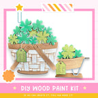 a DIY wood paint kit for creating a wooden basket or planter. The kit includes a basket filled with green shamrocks and a smaller wooden planter with a similar design. The kit is labeled as a "DIY WOOD PAINT KIT" and encourages viewers to "IF WE CAN CREATE IT, YOU CAN MAKE IT!"