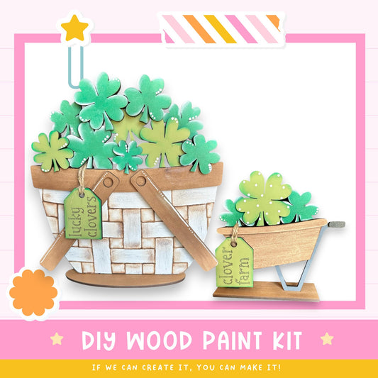 a DIY wood paint kit for creating a wooden basket or planter. The kit includes a basket filled with green shamrocks and a smaller wooden planter with a similar design. The kit is labeled as a "DIY WOOD PAINT KIT" and encourages viewers to "IF WE CAN CREATE IT, YOU CAN MAKE IT!"