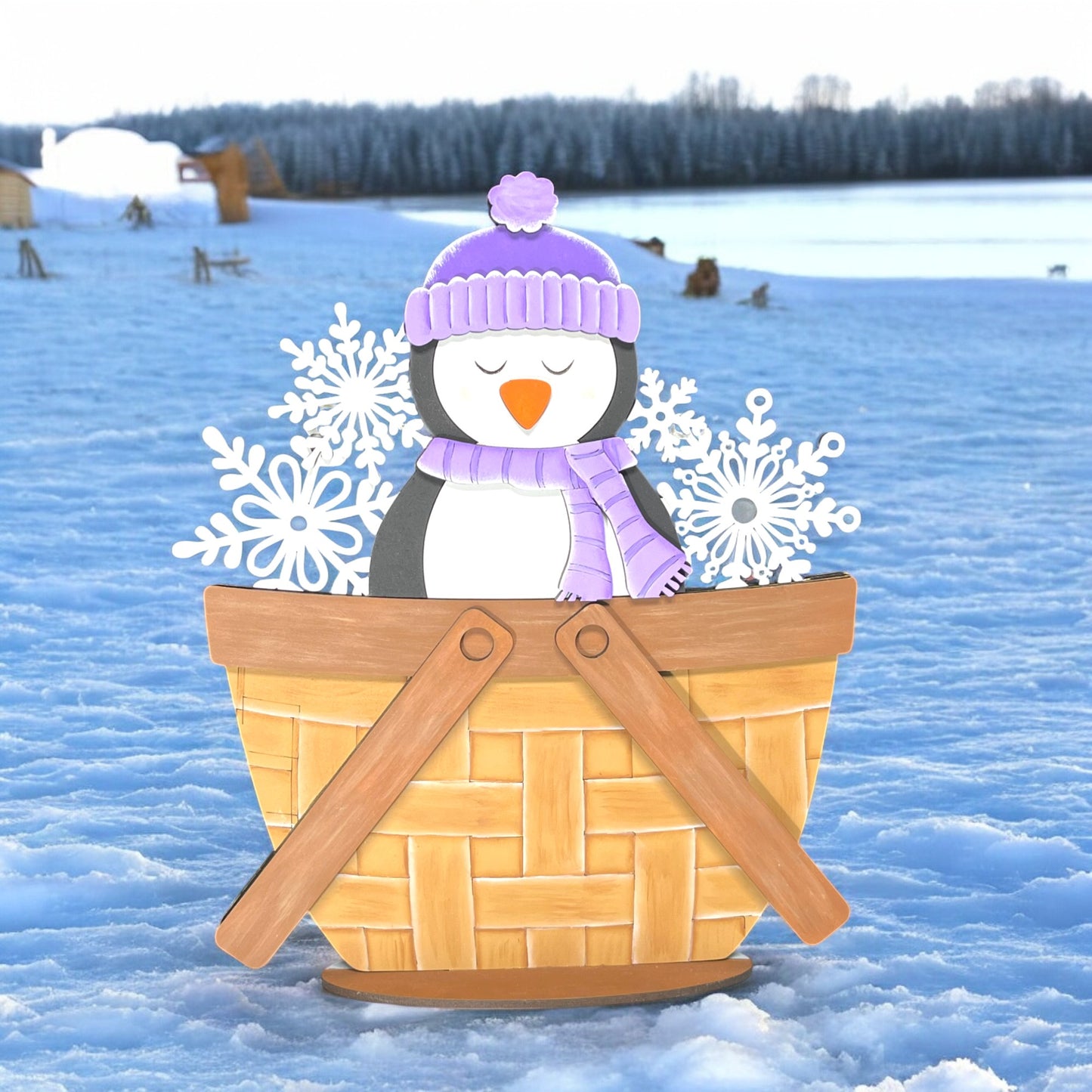 a penguin sitting in a basket with snow flakes