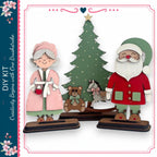 a DIY kit with a Christmas tree and two wooden figures, one of which is Santa Claus. The kit includes a Christmas tree and a teddy bear, as well as instructions for creating a wooden figure of Santa Claus and a wooden figure of an elderly woman.