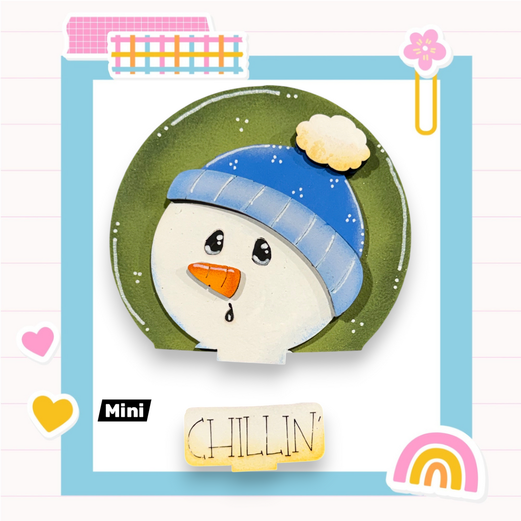 A snowman wearing a blue hat and holding a carrot, with the word "CHILLIN'" written below it, is surrounded by various colorful and whimsical elements such as hearts, a rainbow, and a flower.