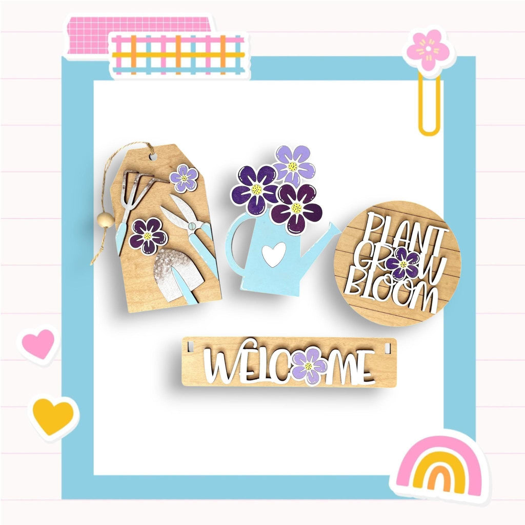 a wooden sign with flowers and a watering can