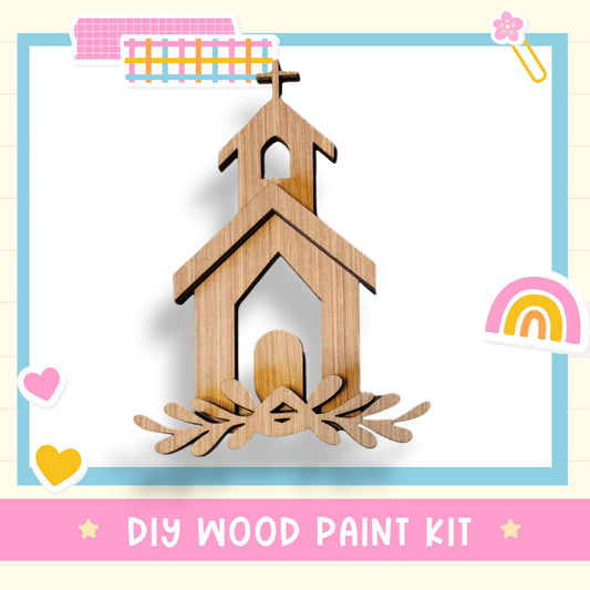 a wooden craft kit with a church and a rainbow