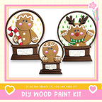 three wooden gingerbread man figurines, each with a unique design and color, displayed in a decorative arrangement.