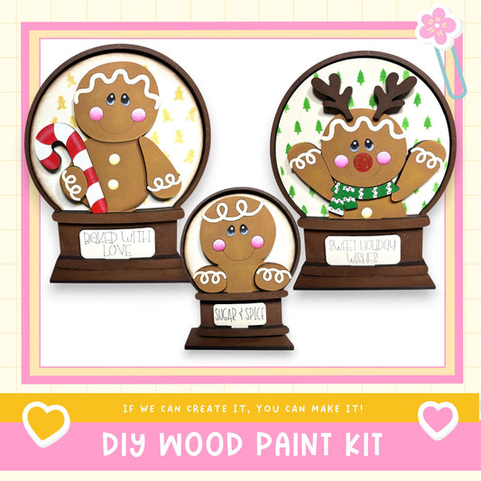 three wooden gingerbread man figurines, each with a unique design and color, displayed in a decorative arrangement.