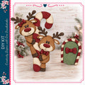 A festive scene featuring two wooden reindeer figures, one standing on a candy cane and the other sitting on a green door, set against a backdrop of holiday decorations and greenery.