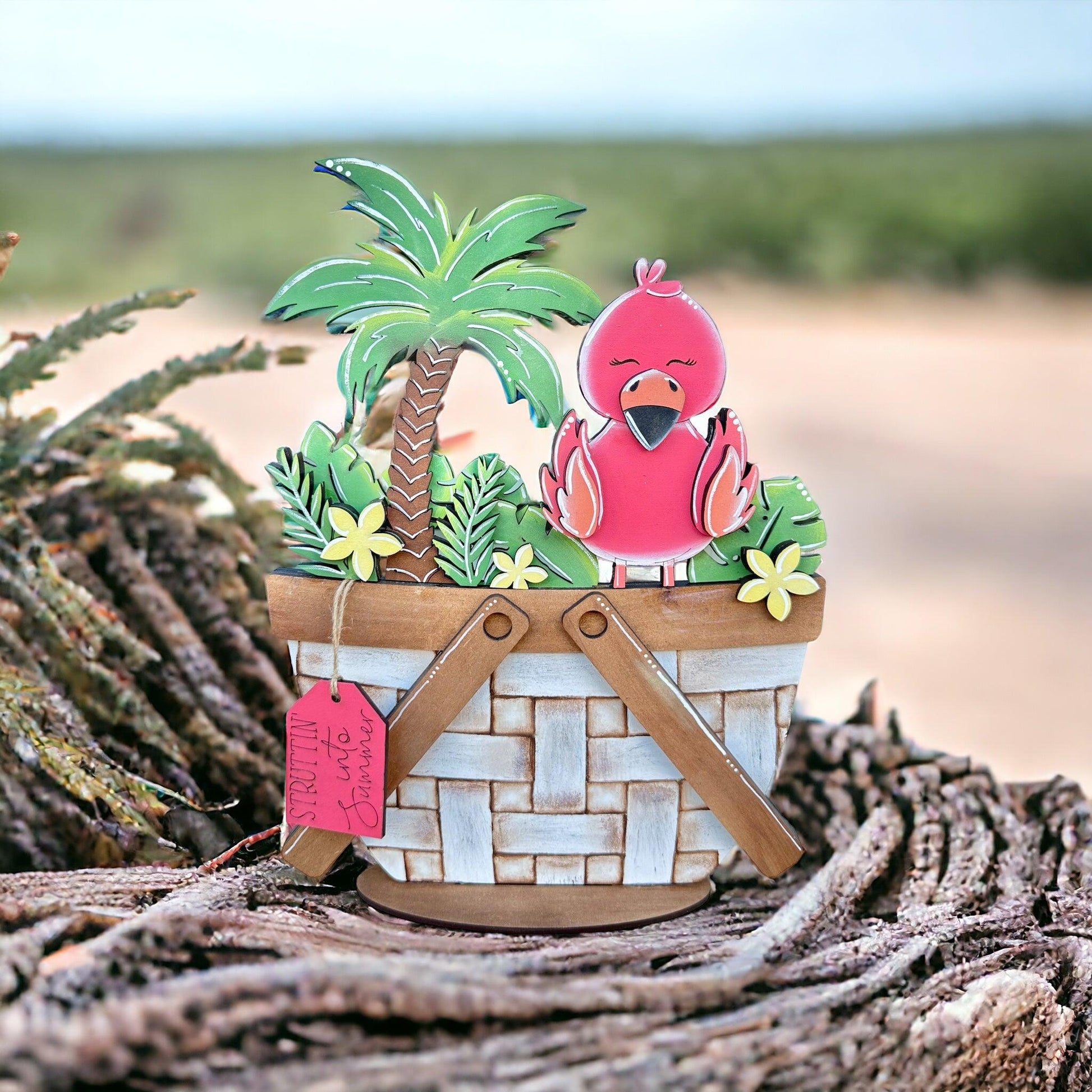 a pink bird sitting in a basket with a palm tree