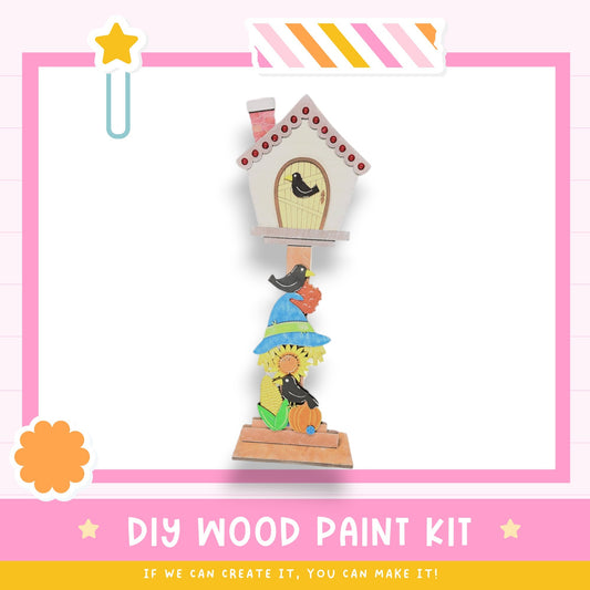 a picture frame with a birdhouse on top of it