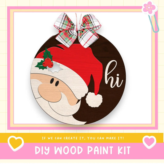 a wooden christmas ornament with a santa clause on it