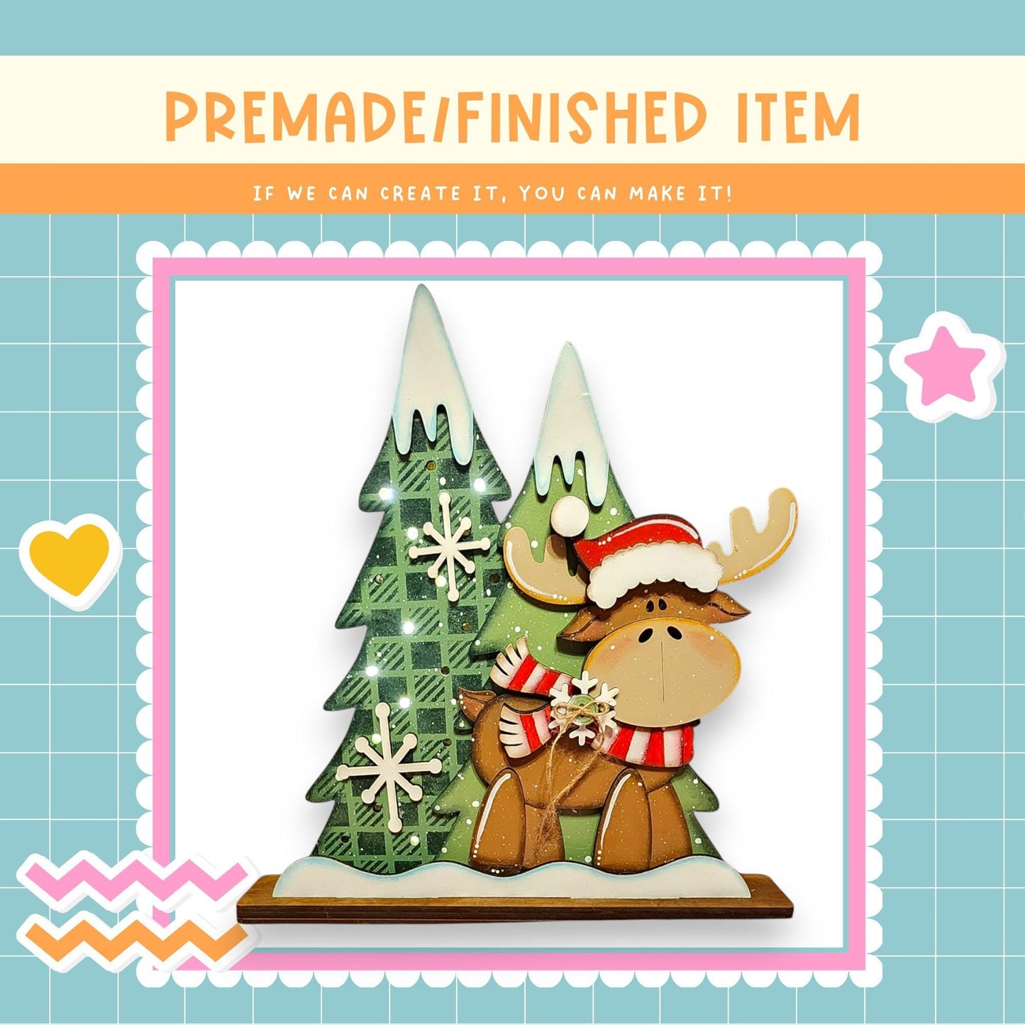 a wooden moose figure wearing a red and white scarf, standing next to a Christmas tree decorated with snowflakes.