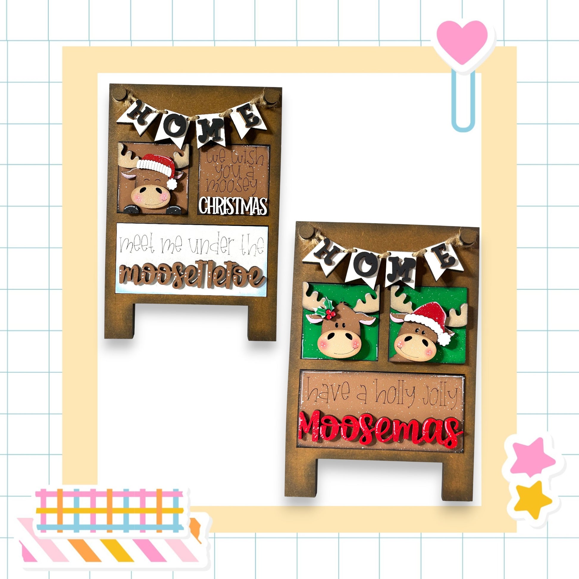 two wooden signs with holiday-themed decorations, including moose heads and Christmas-related text. The signs are set against a grid background with various colorful stickers and a heart-shaped object.