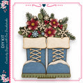 A pair of blue snow boots adorned with a floral arrangement of red, pink, and white flowers, along with snowflakes and pine branches.