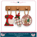 a DIY kit for creating a "Cookies for Santa" ornament, which includes a cookie cutter, a mitten, and a cookie jar. The kit is designed to be a creative and fun project for those who enjoy crafting and decorating during the holiday season.