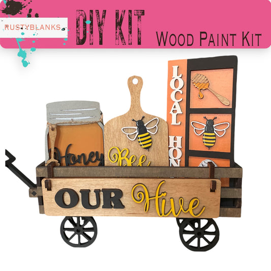 a wooden paint kit with bees and honey on it