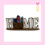 A wooden sign with the word "HOME" in large letters, with a basket filled with colorful fireworks placed underneath it.
