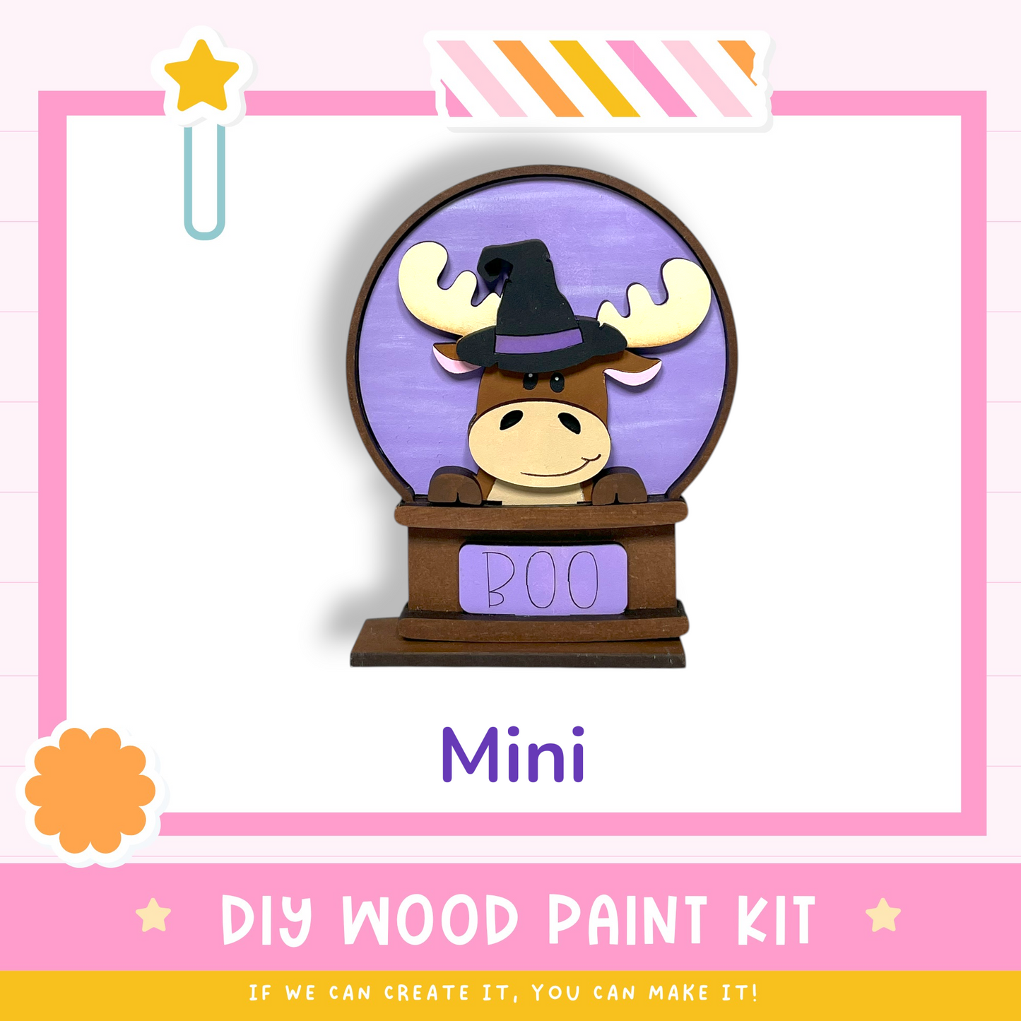 a wooden snow globe with a moose wearing a witch's hat, labeled "BOO" and "Mini". The background is pink and white, and there is a text box at the bottom that reads "DIY WOOD PAINT KIT" and "IF WE CAN CREATE IT, YOU CAN MAKE IT!"