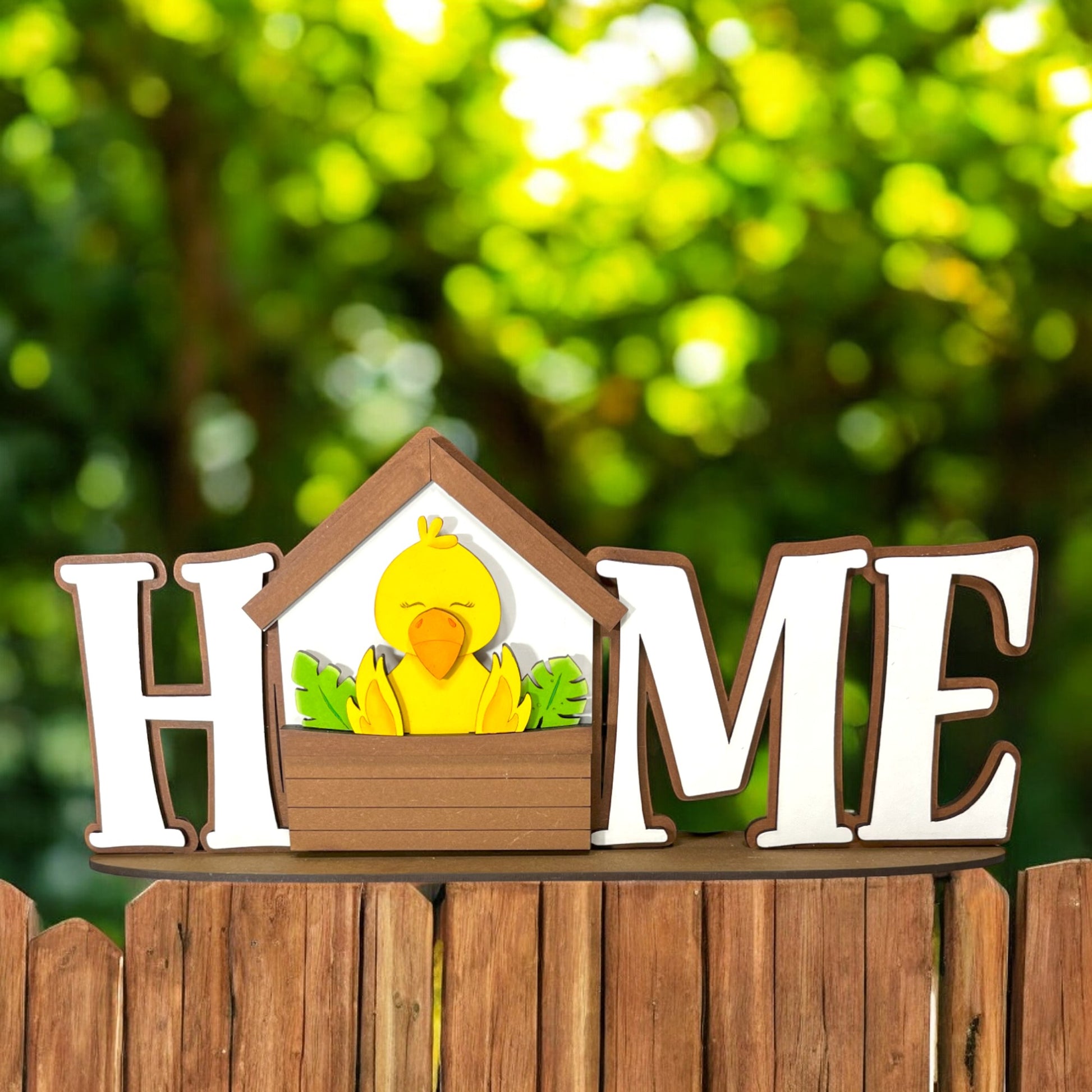 a wooden sign that says home with a duck in it