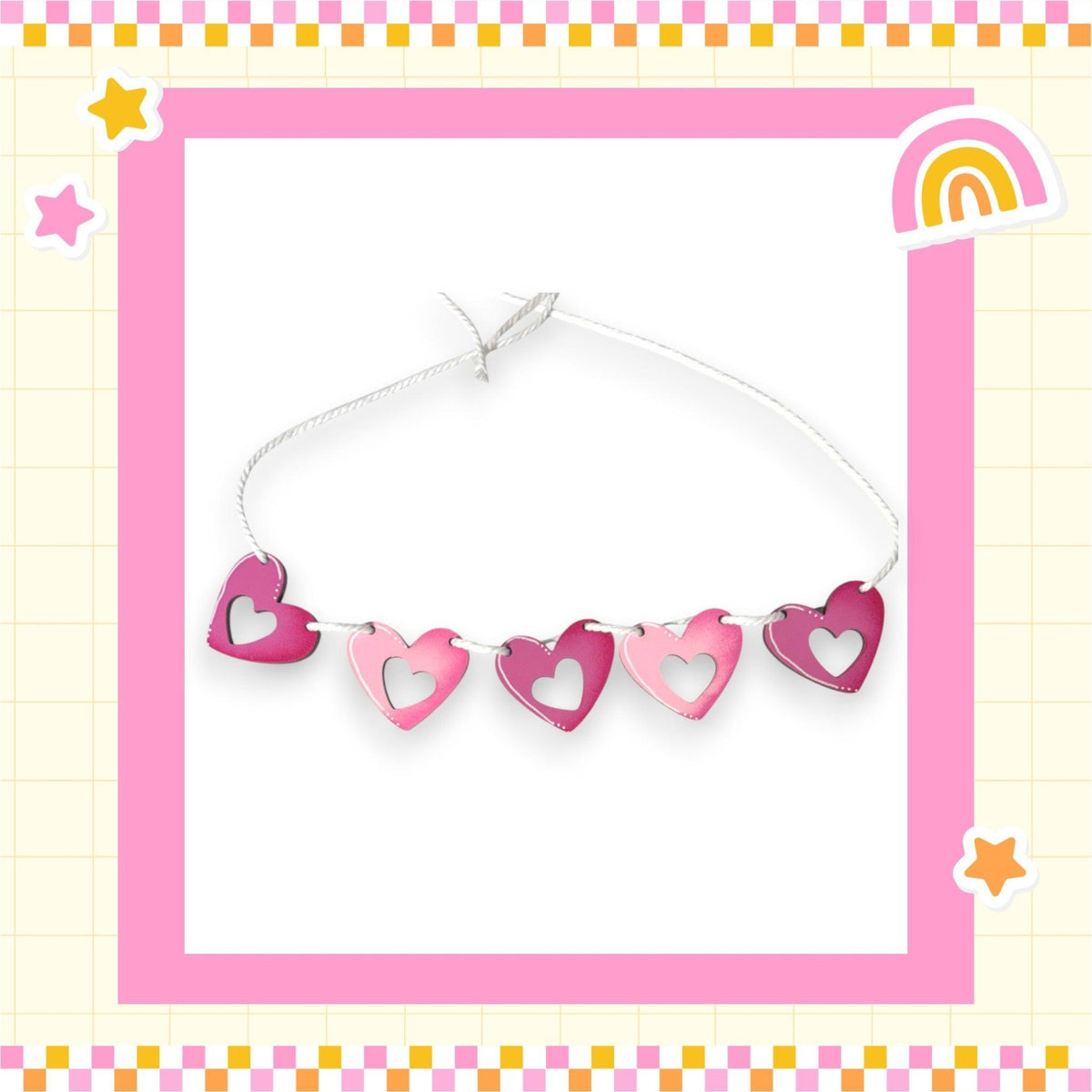 a picture of a string of hearts with a rainbow in the background