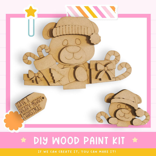 a DIY wood paint kit for creating wooden toys, including a bear and a teddy bear. The kit appears to be made of wood and includes a label that says "Have a BABY-MERRY CHRISTMAS".