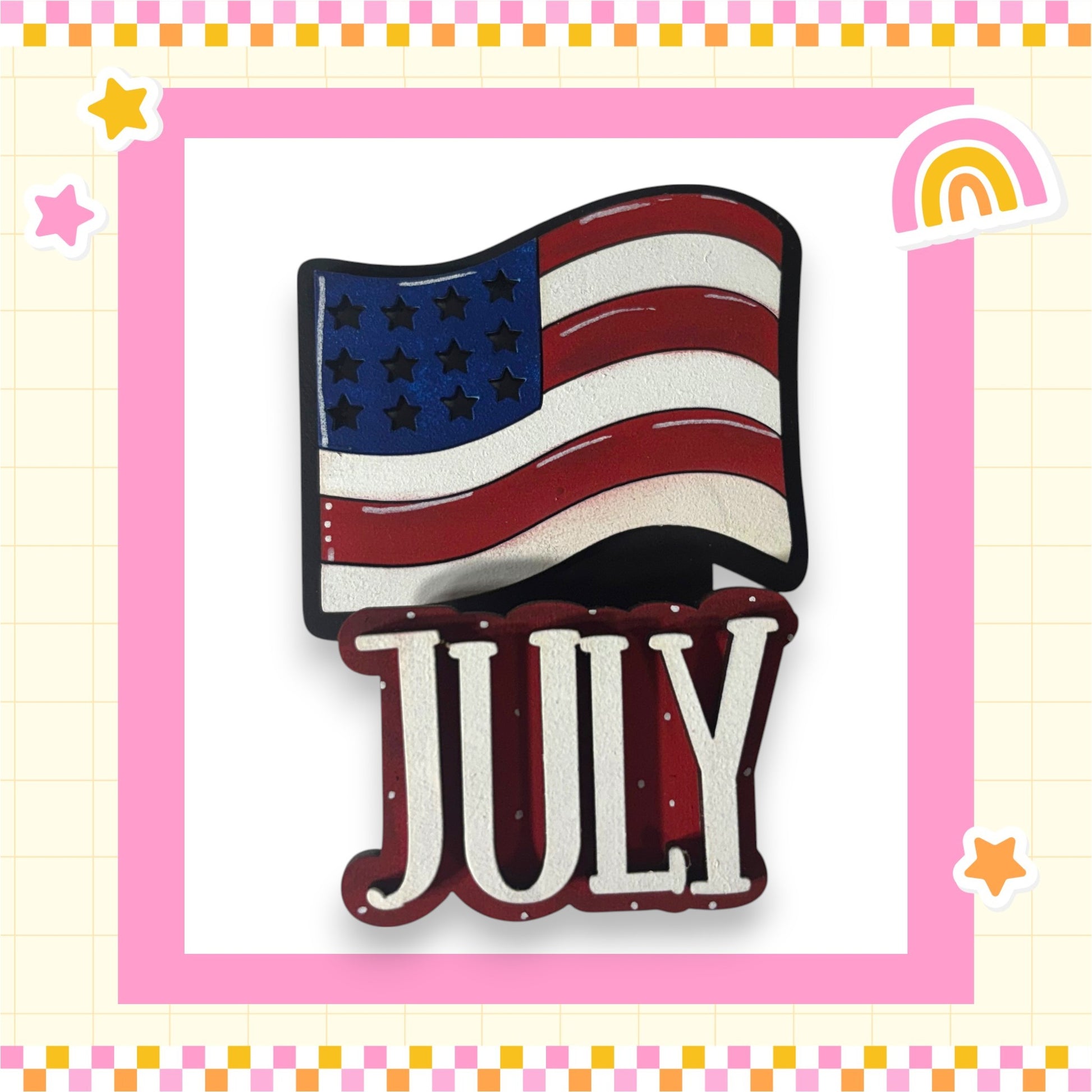 a large American flag with the word "July" written below it, set against a pink and yellow checkered background with stars and a rainbow.