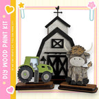 a wooden barn and a green tractor, with a cow figurine sitting next to the tractor.