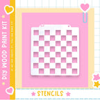 a DIY wood paint kit with a pink background and a white stencil in the center.