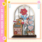 A wooden display featuring a floral arrangement and the text "Happy Mother's Day" in a decorative wooden frame.