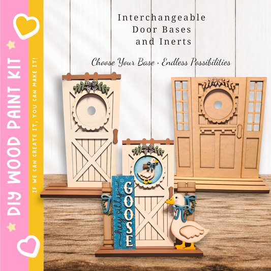 a DIY paint kit for creating door bases and inerts. There are three wooden door bases displayed, each with different designs and decorations. A small wooden bird figurine is also present on the table. The kit appears to be designed for people to customize their door bases and inerts according to their preferences.