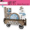 a wooden craft kit with a snowman in a wagon