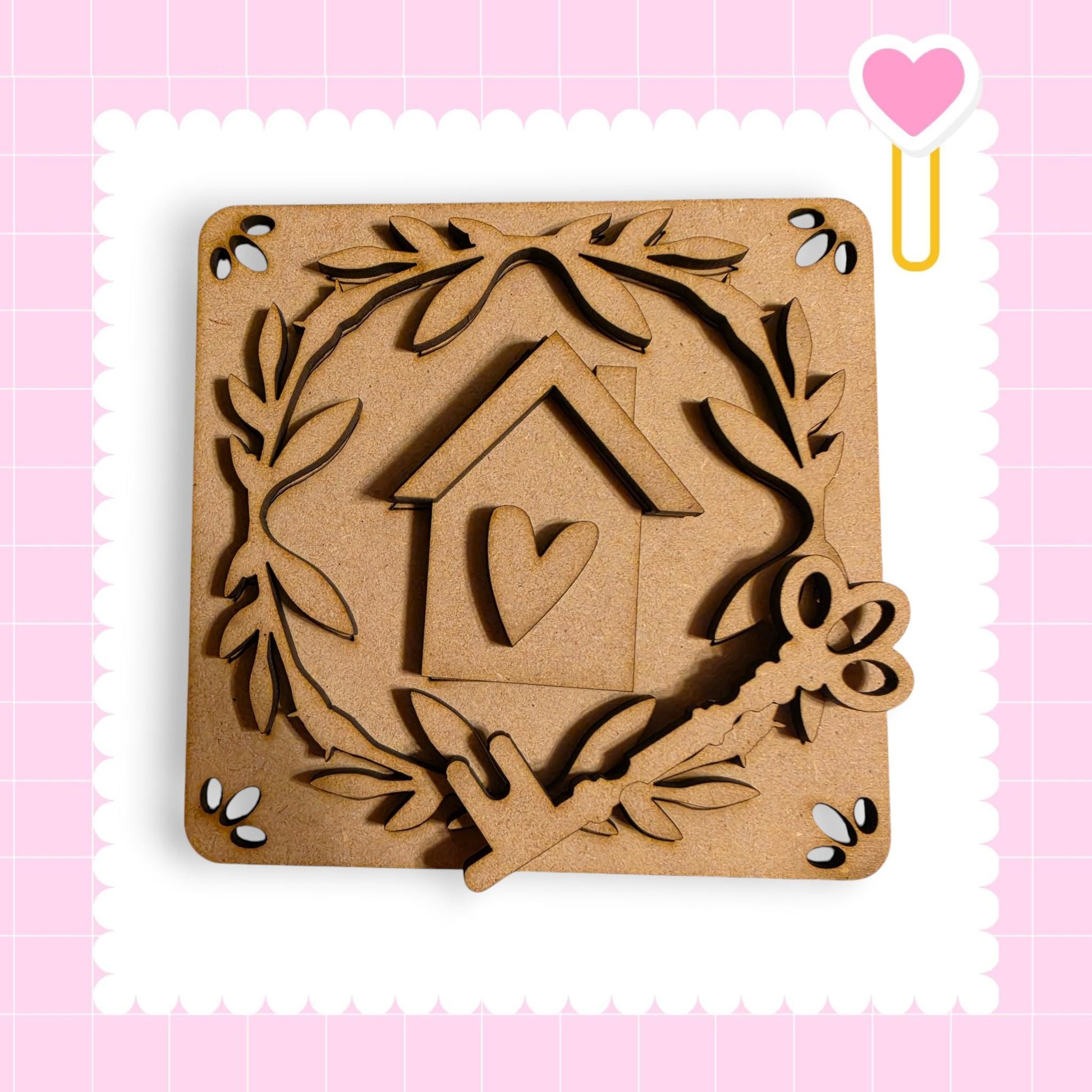 a wooden house key and a heart-shaped cutout, all set against a pink background with a scalloped edge.