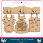 three wooden ornaments hanging on a wall, including a reindeer, a gift bag, and a present.