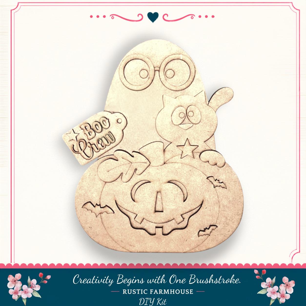 a Halloween-themed DIY kit, including a carved pumpkin, a cat, and a ghost. The kit is designed to spark creativity and is available at Rustic Farmhouse.