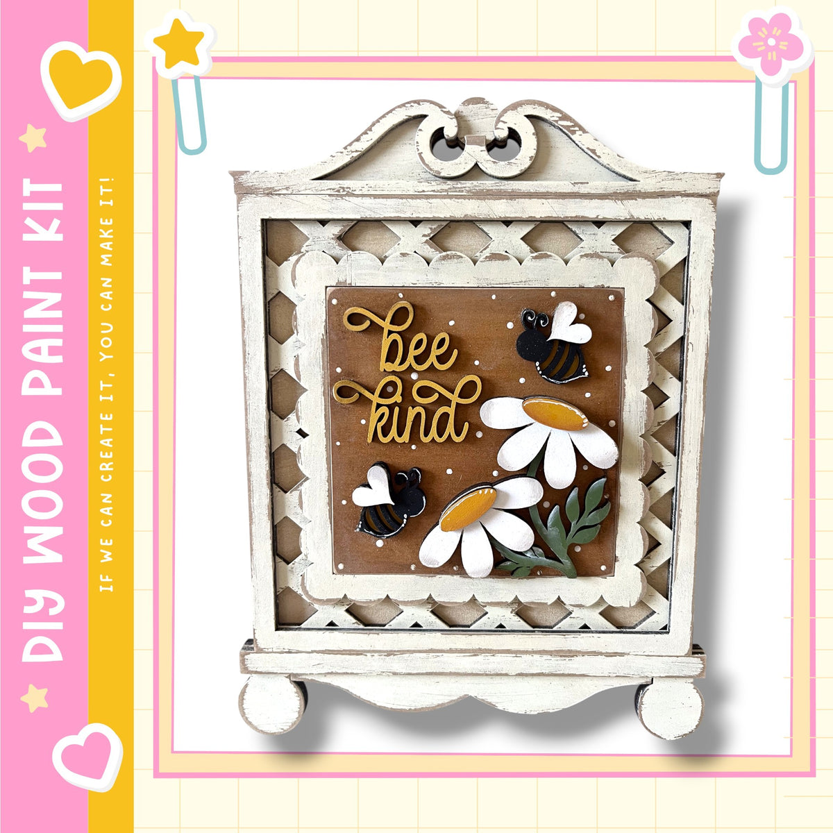 a decorative wooden frame with a floral design and the text "bee kind" written on it. The frame is set against a white background, and there are small flowers and bees on the frame.