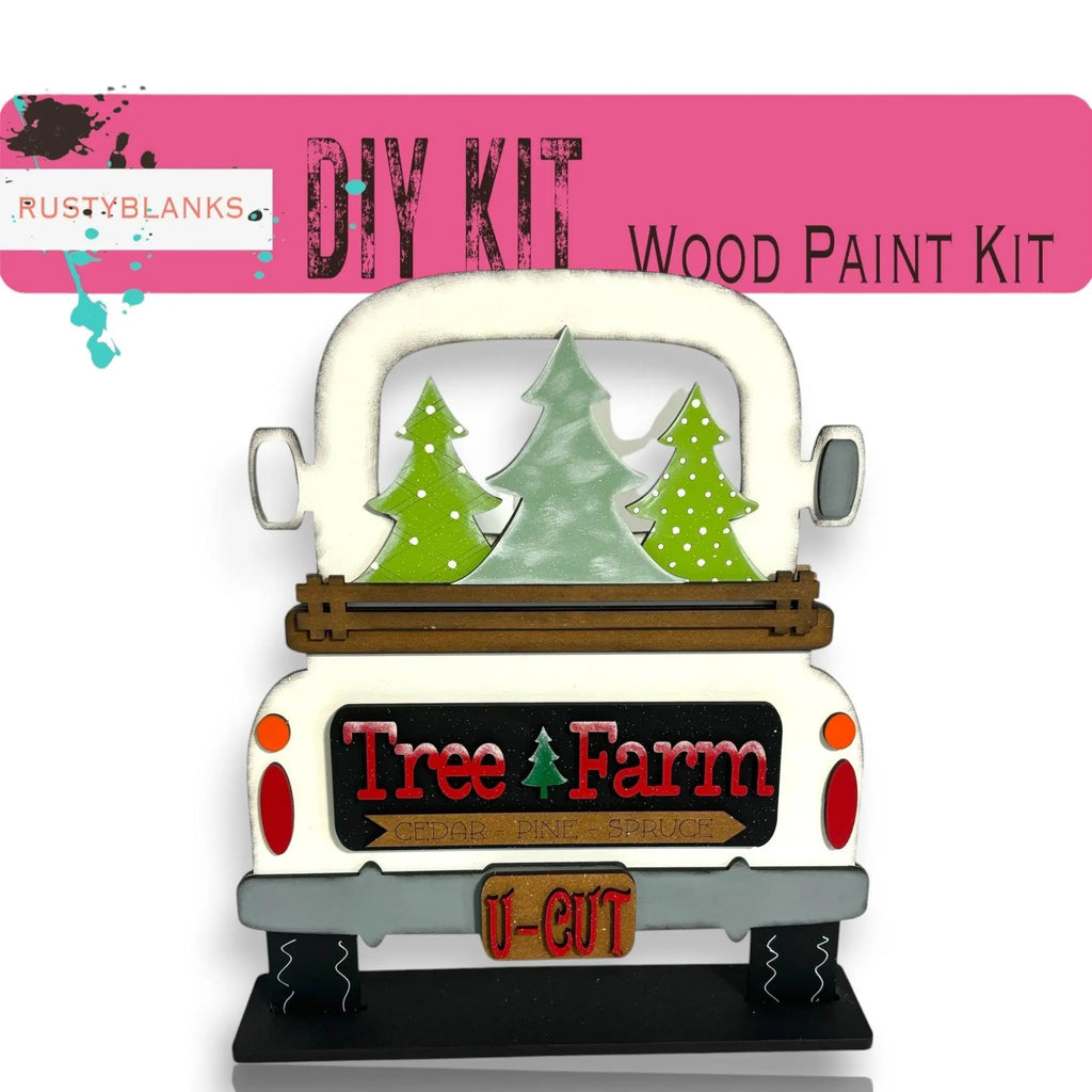 a white truck with trees on the back of it