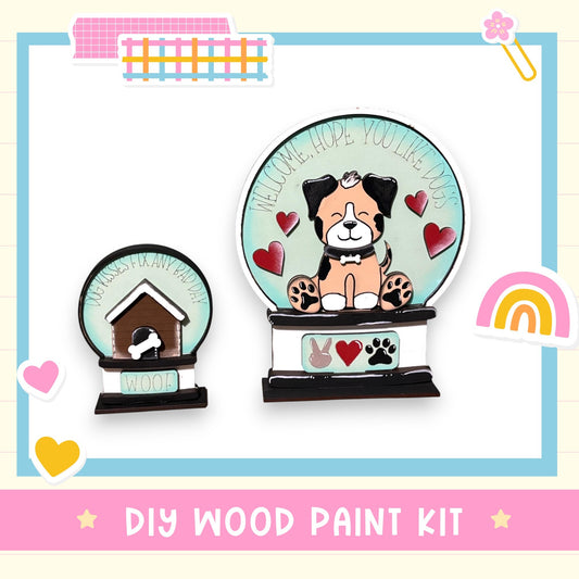 The image is a DIY wood paint kit featuring a wooden dog house and a wooden snow globe with a dog inside.