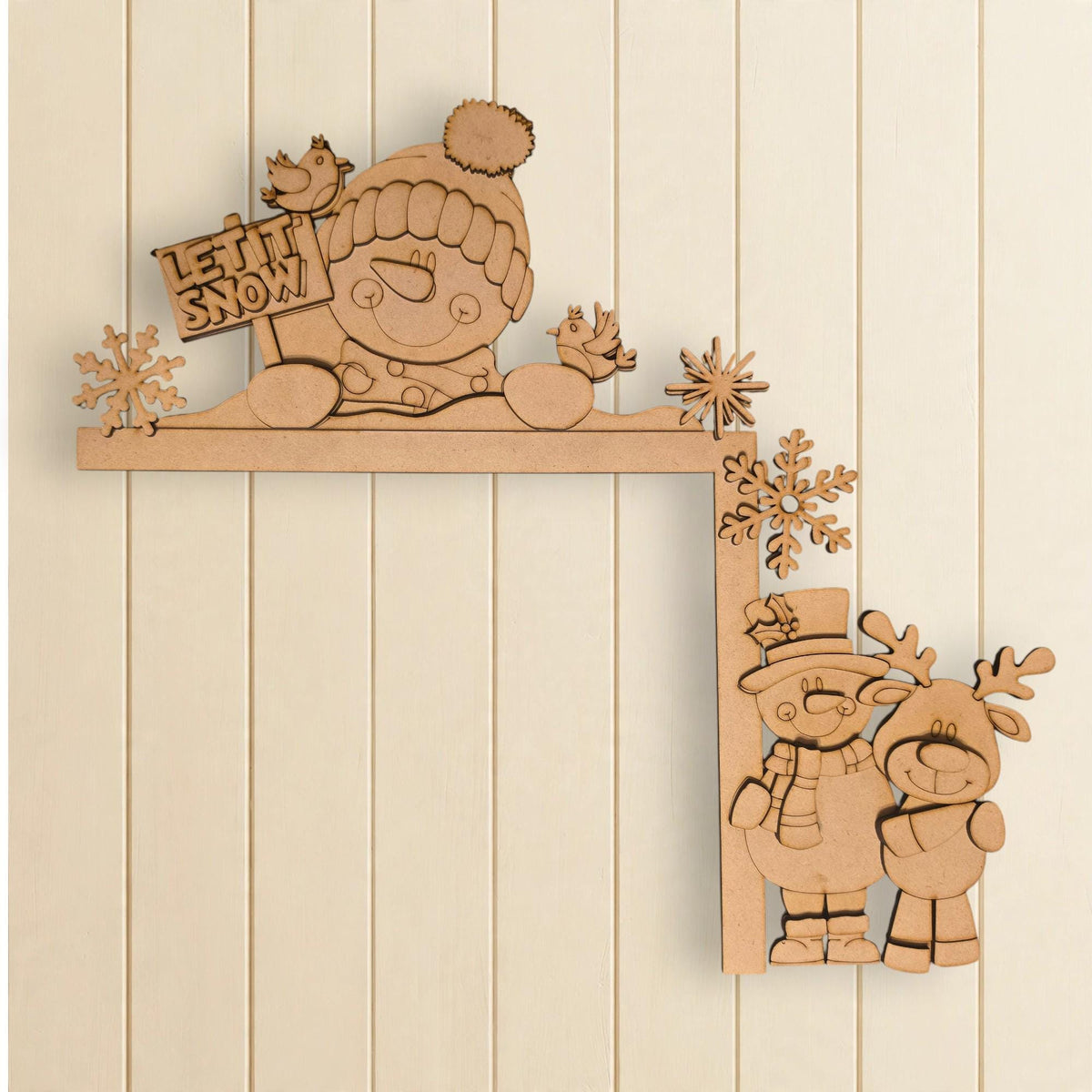 A wooden shelf with a snowman and two reindeer on it, along with a sign that says "LET'S SNOW".