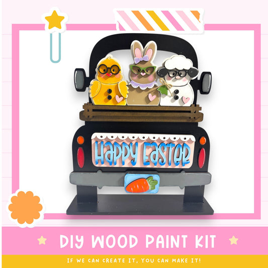 A DIY wood paint kit for creating a wooden Easter decoration, featuring a truck with a bunny, chicken, and sheep on the back.