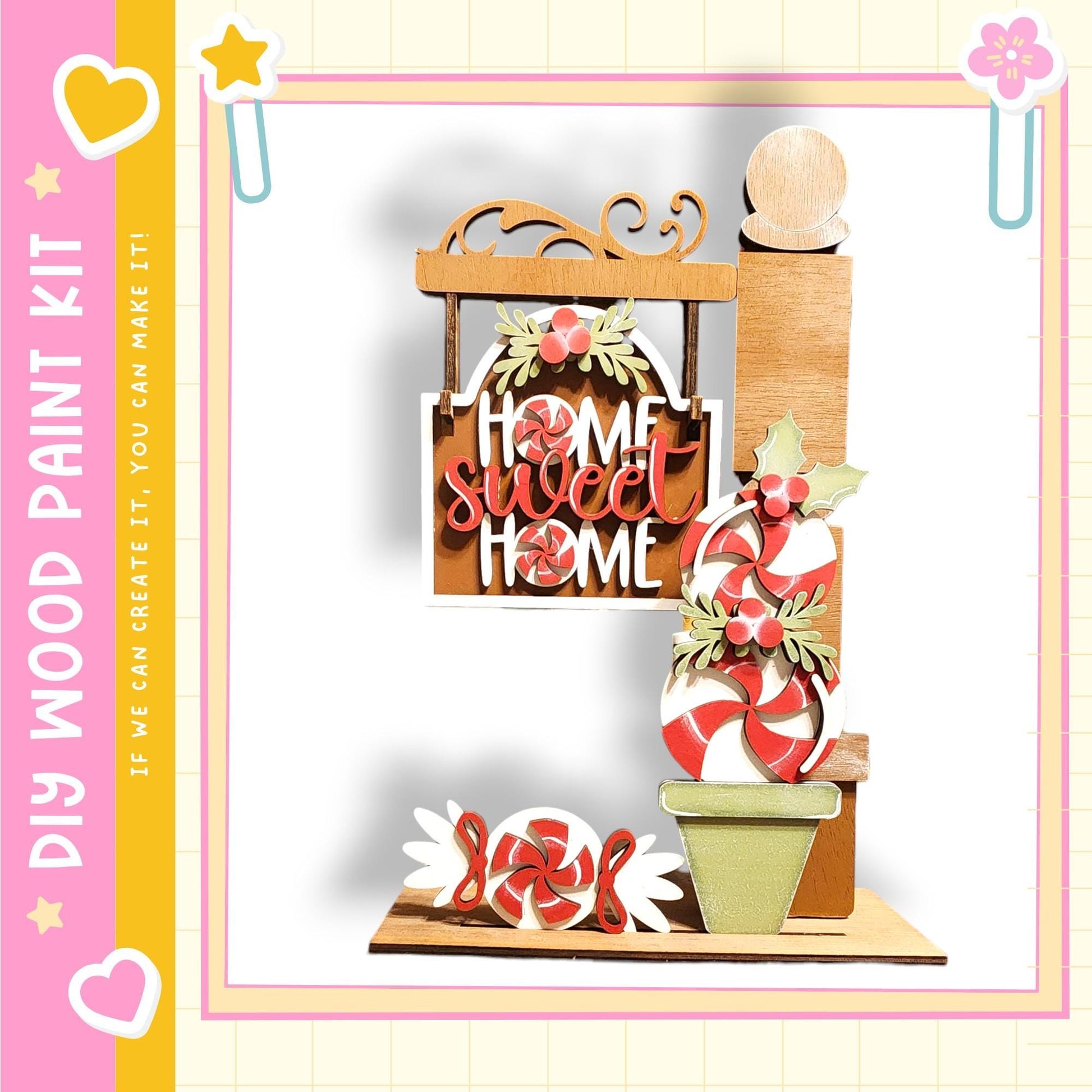 The image is a colorful and festive display featuring a wooden sign that says "Home Sweet Home", surrounded by various candy-like items such as candy canes, peppermints, and other sweets.