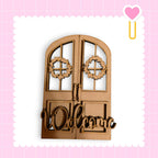 a wooden door with a wreath and the word "Welcome" written on it.